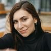 Outdoor portrait of pretty young brunette female taking selfie flirty smiling at camera. Charming girl looking at camera with happy joyful expression and gesturing hands frame. Selective focus on face